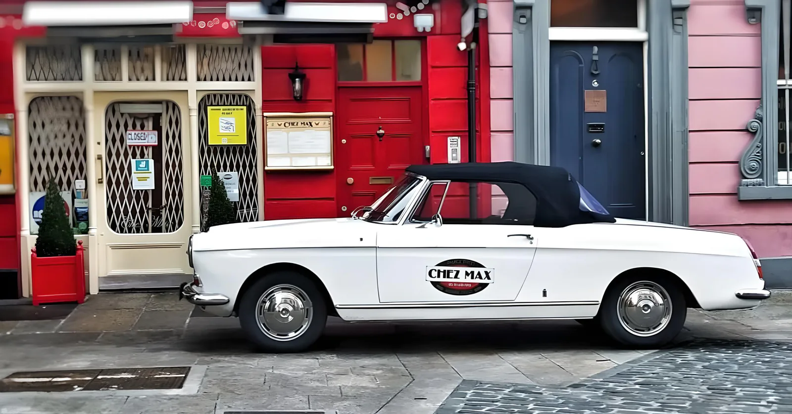 The red Chez Max shopfront on Palace Street, with the restaurant’s vintage white Peugeot parked outside