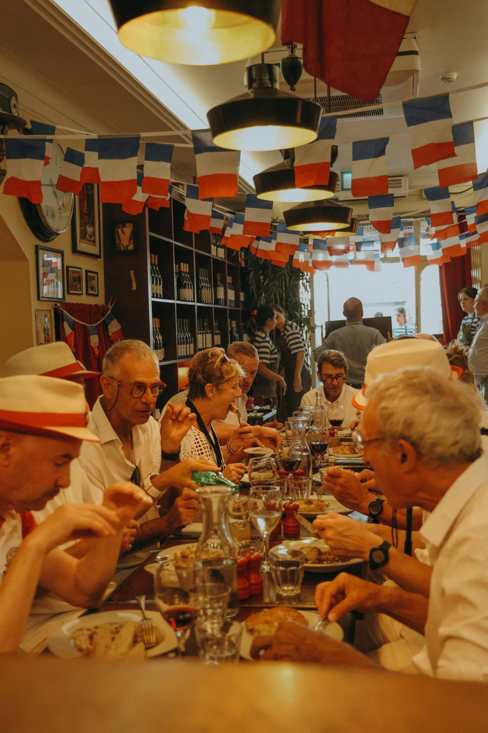 Long tables under French flag bunting inside Chez Max on Bastille Day