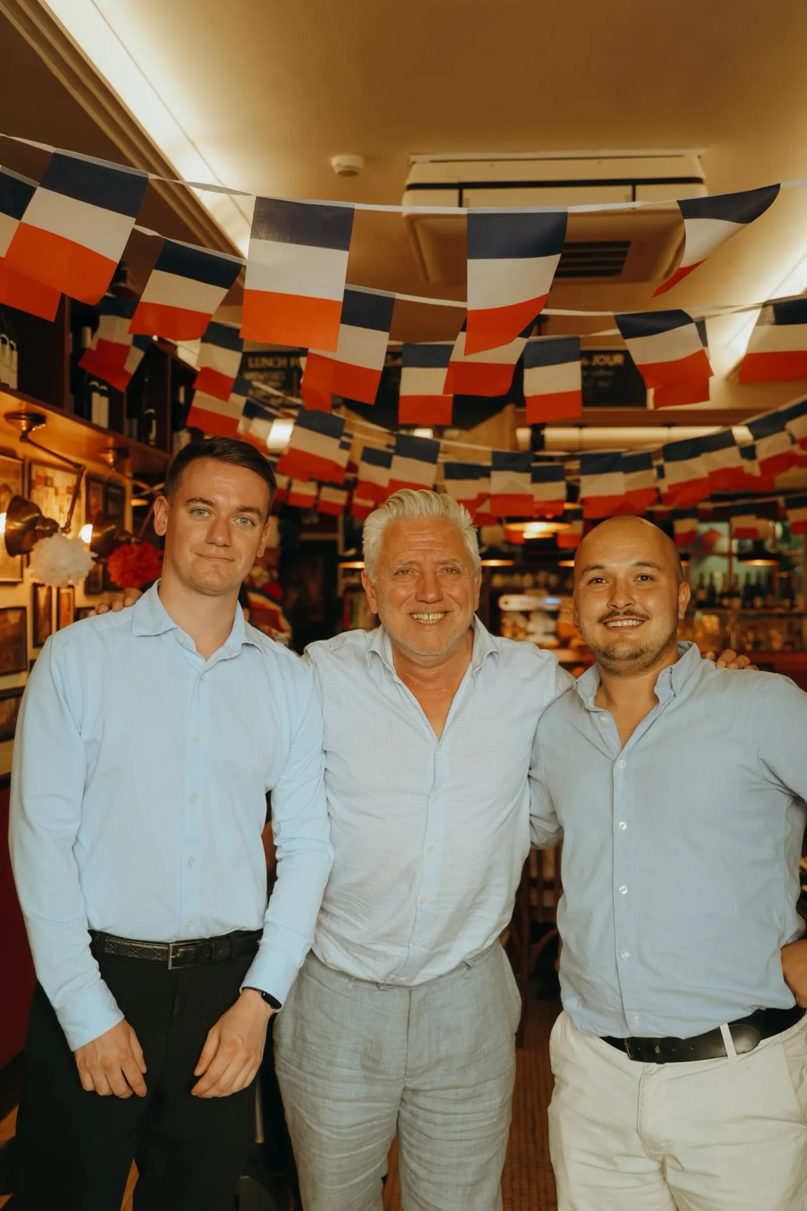 Max and the team under the tricolour bunting on Bastille Day