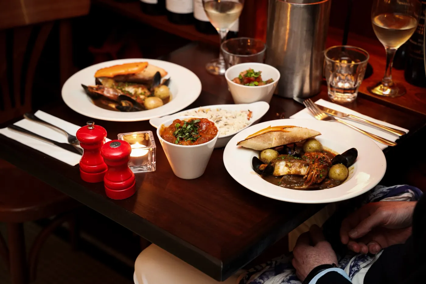 Moules, tian and a glass of rosé on a table set for Provence Night