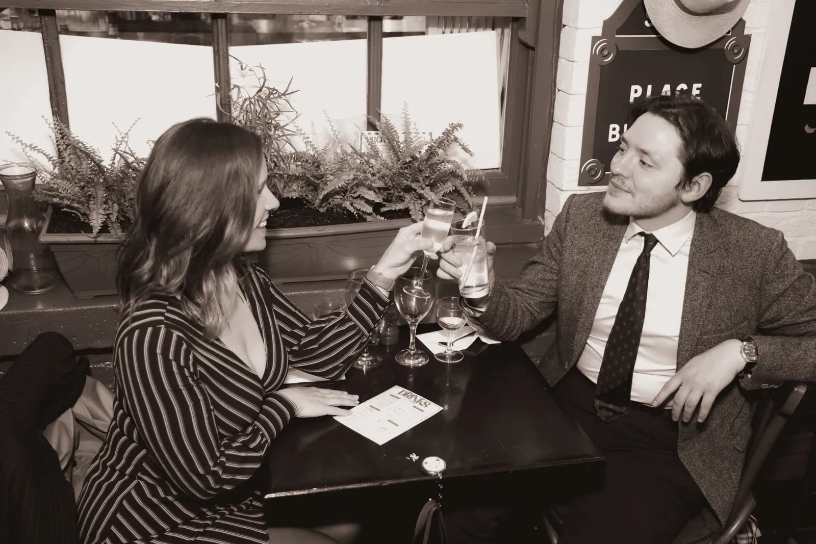 Two guests raising a glass by the window on Provence Night
