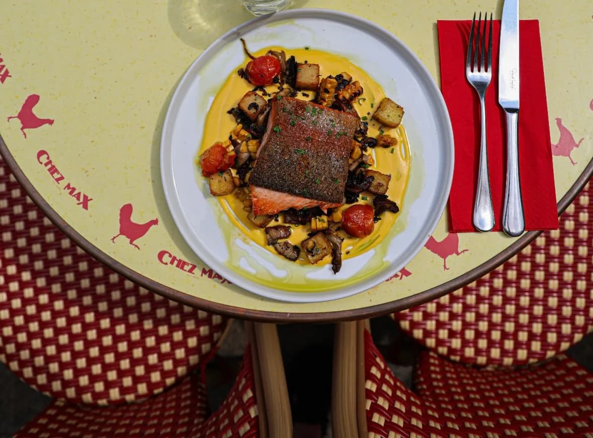 Pan-seared salmon on a Chez Max terrace table