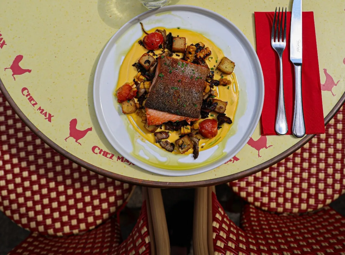 Pan-seared salmon on a Chez Max terrace table