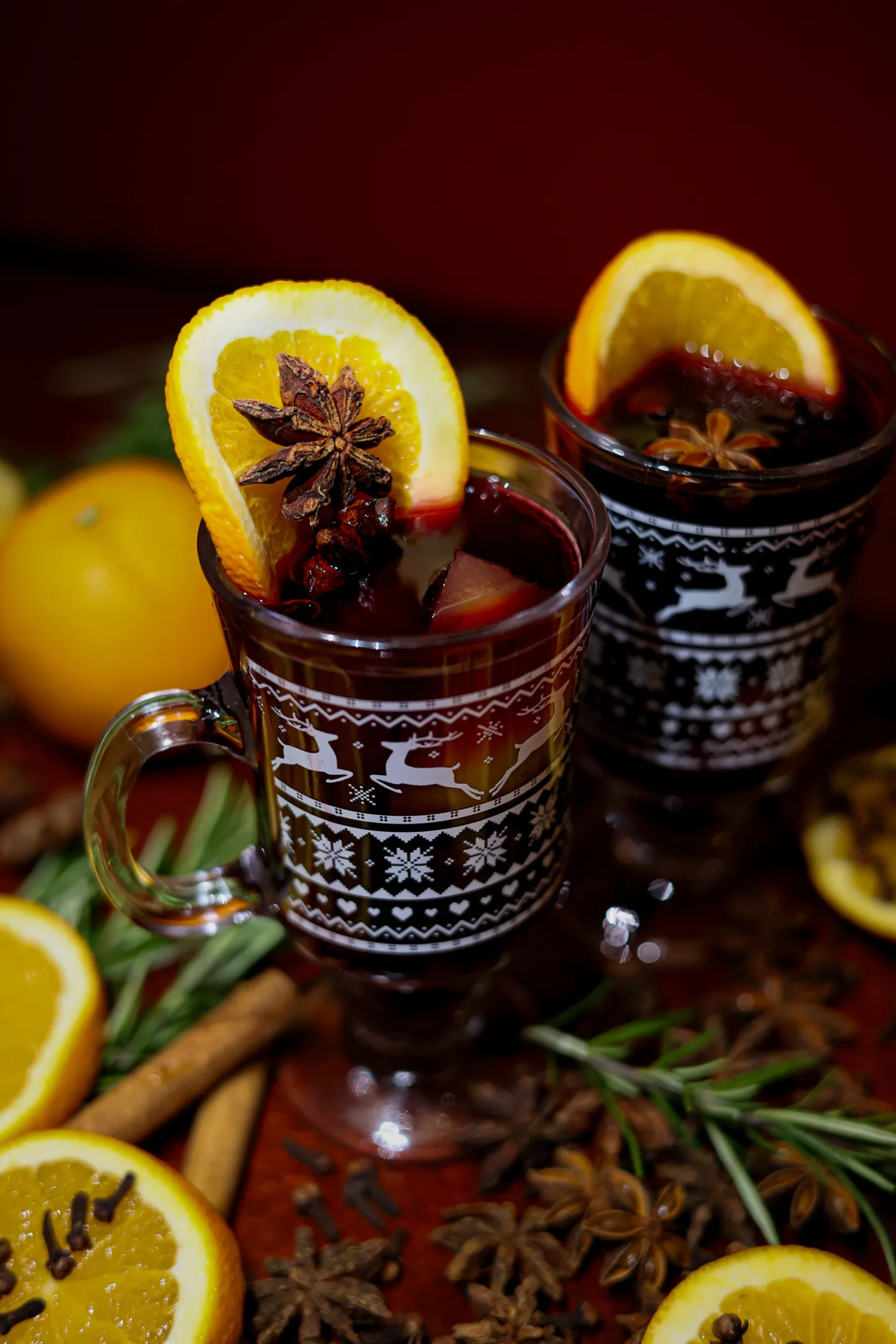 Two glasses of mulled wine with orange and star anise