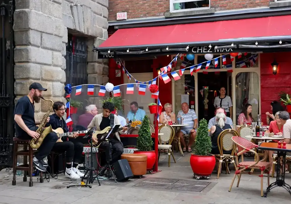 Guests celebrating Bastille Day at Chez Max on Palace Street